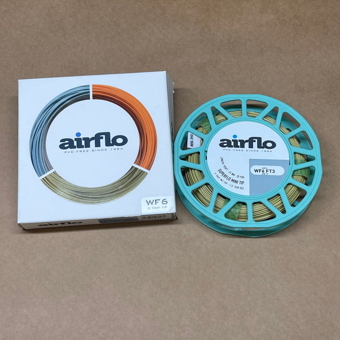 Airflo fishing line spool and packaging on a brown background